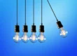Row of hanging lightbulbs against a gradient blue background